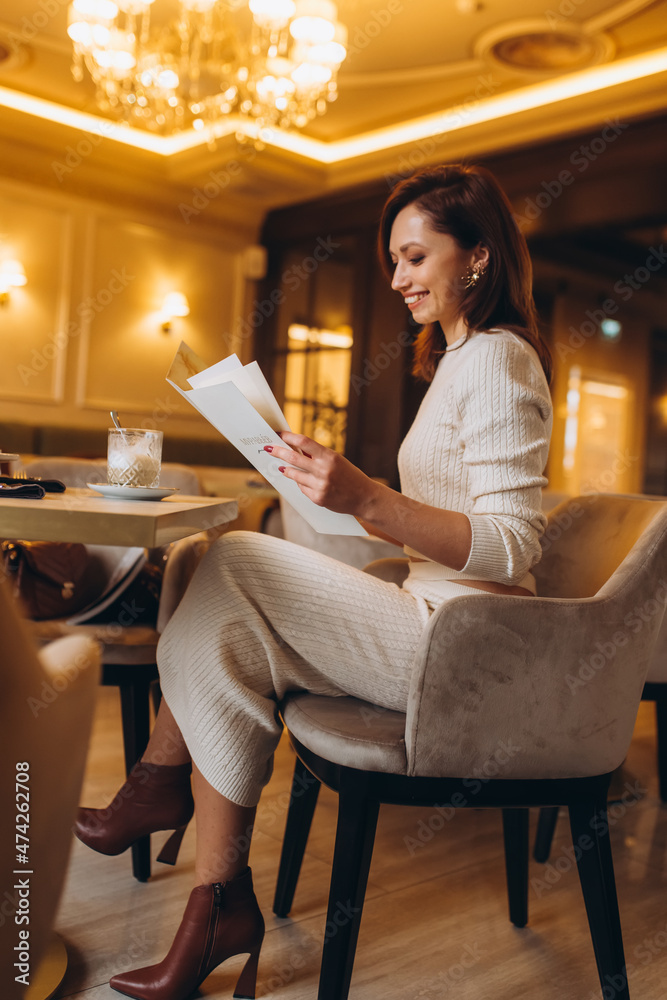 Beautiful woman portrait in luxury restaurant. Rich stylish caucasian brunette girl Beautiful woman portrait in luxury restaurant. Rich stylish caucasian brunette girl