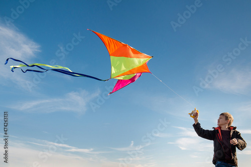 A boy of 10 years old with a kite against the sky. Bright sunny day. Flight