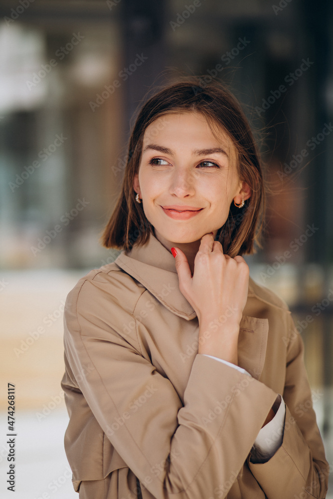 Young beautiful woman wearing coat walking in the city Young beautiful woman wearing coat walking in the city