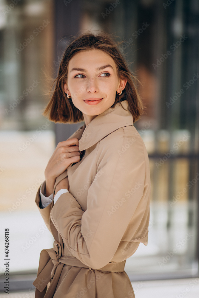 Young beautiful woman wearing coat walking in the city