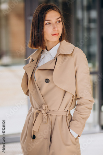Young beautiful woman wearing coat walking in the city
