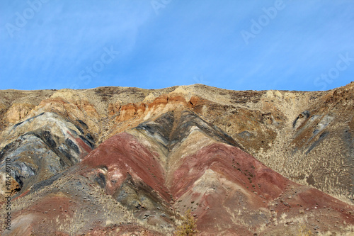 Exposed rock layers. Red and brown soil layers. 