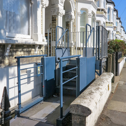 London, England - April 20 2019 - A house in Balham, London, England with an adaptive wheelchair lift outside a house.  This can allow disabled people and wheelchair users access to the house. photo