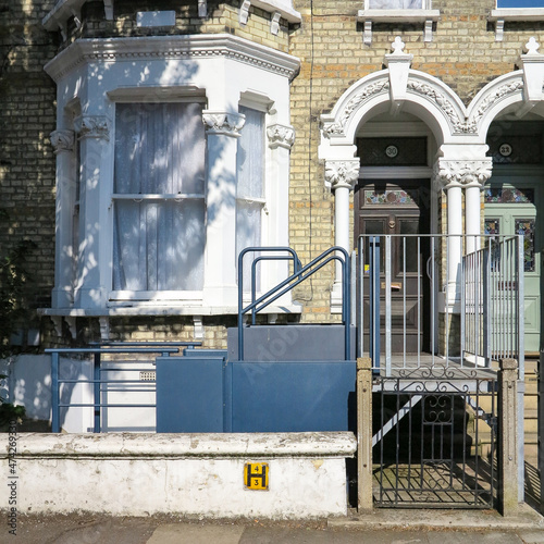 London, England - April 20 2019 - A house in Balham, London, England with an adaptive wheelchair lift outside a house.  This can allow disabled people and wheelchair users access to the house.