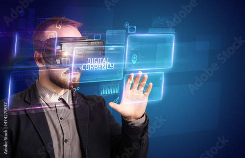 Businessman looking through Virtual Reality glasses, tech concept