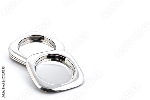 Set of metallic coasters for drinks in silver color isolated on white background with space for text © Valente