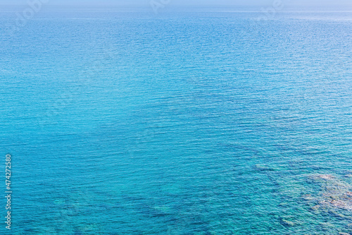 marine background, transparent blue coastal littoral over coral reef