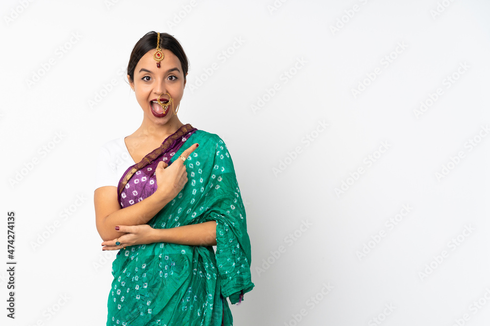 Young indian woman isolated on white background surprised and pointing side Young indian woman isolated on white background surprised and pointing side
