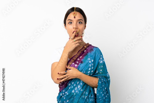 Young indian woman isolated on white background surprised and shocked while looking right
