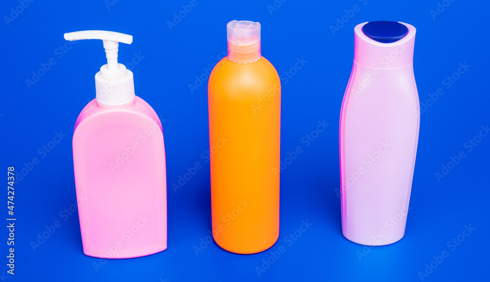 Easy to refill and dispense. Toiletry bottles in row. Refillable bottles blue background Easy to refill and dispense. Toiletry bottles in row. Refillable bottles blue background