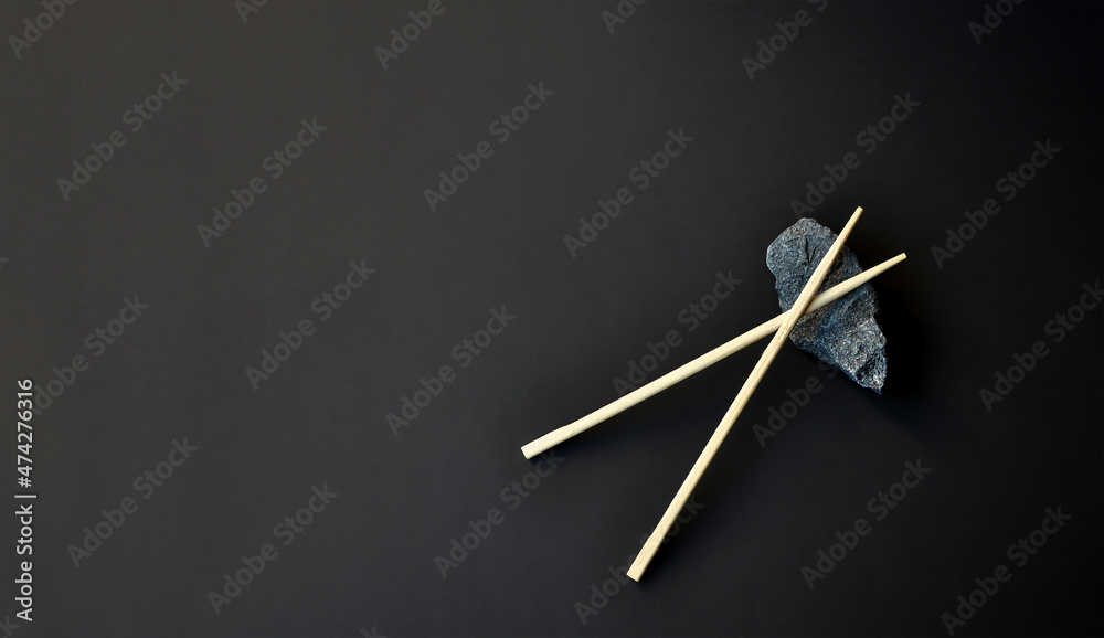 Dark background. Chinese food sticks. East Asian vibes. Minimalism Dark background. Chinese food sticks. East Asian vibes. Minimalism