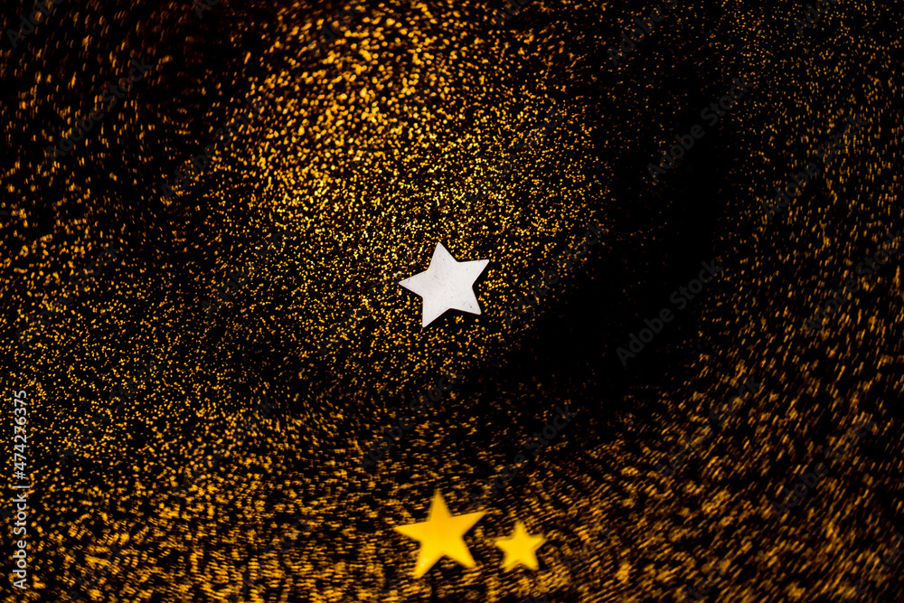 Golden bokeh background with vortex swirl and stars