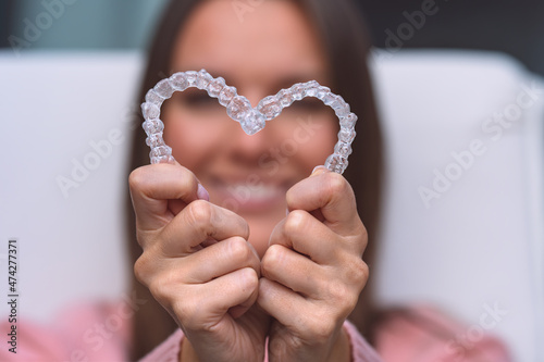 Woman with dental invisible invisalign braces or silicone trainer. Aligners treatment