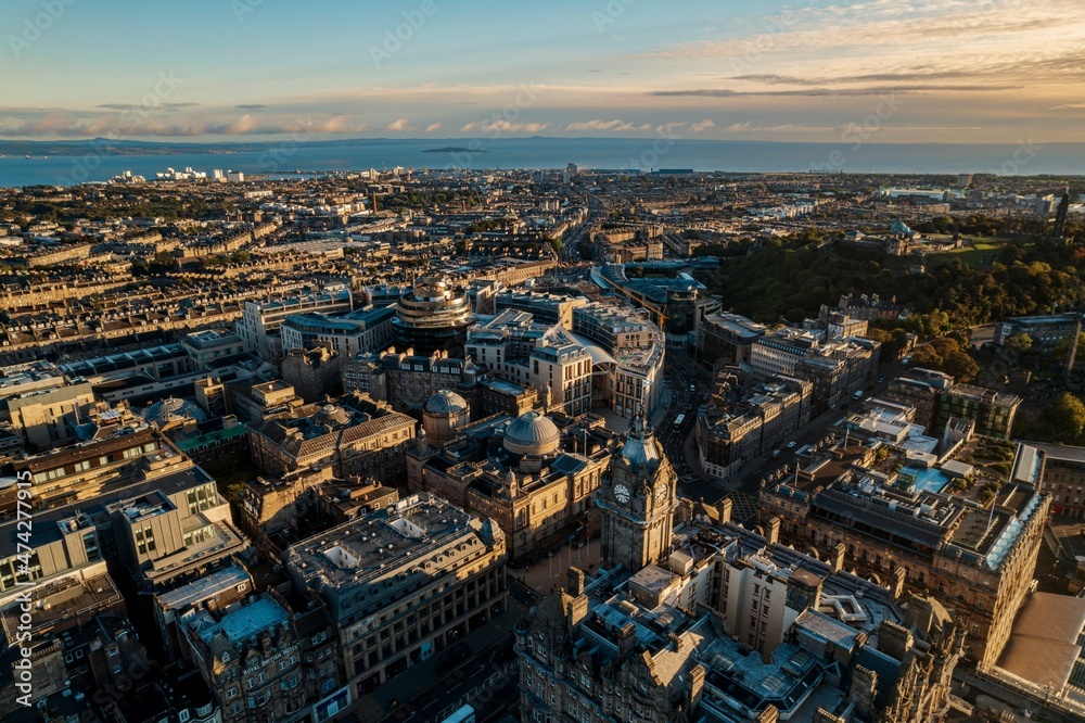 Aerial view of Edinburgh as sun rises over the city. Old city wakes up with the sunrise. Early morning haze lifts as the first rays of sunlight hit the city of Edinburgh, Scotland