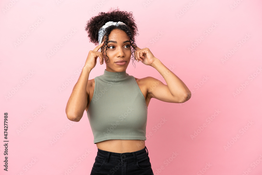 Young latin woman isolated on pink background having doubts and thinking Young latin woman isolated on pink background having doubts and thinking