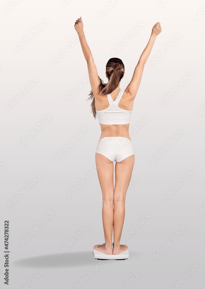 Beautiful young woman with measuring scales after weight loss on background Beautiful young woman with measuring scales after weight loss on background