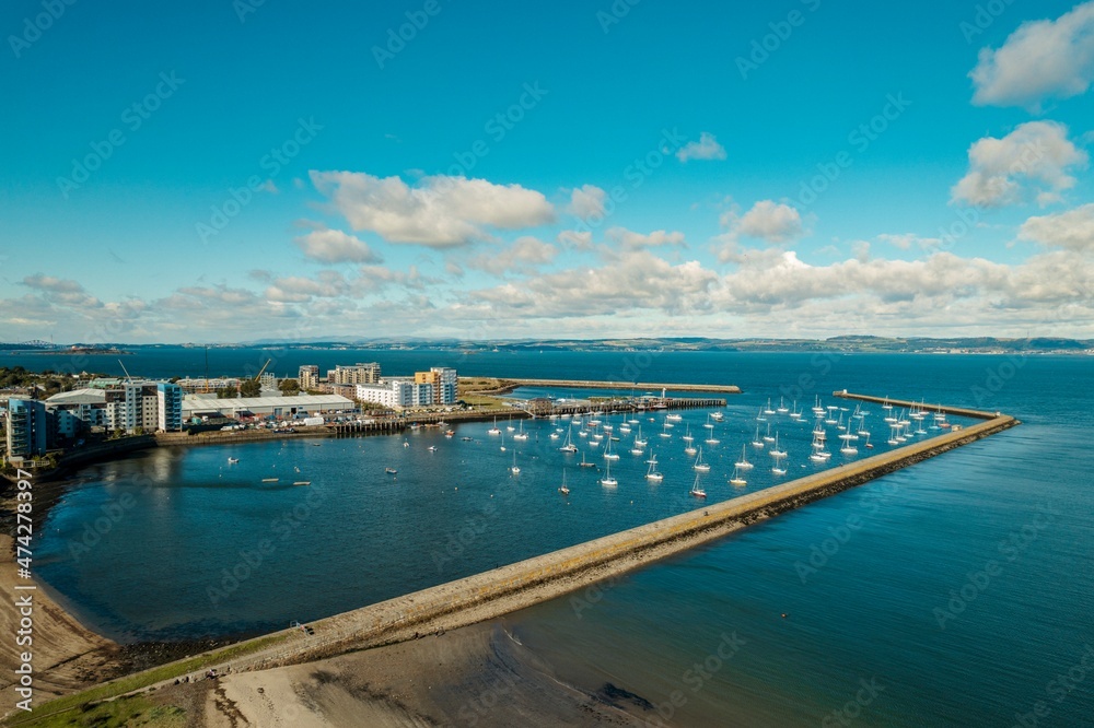 Iconic marina, located along the east coast of Scotland, presents a stunning view of the sea. Taking an aerial view of the marina, image displays a stunning image of the marina large yachts and boats