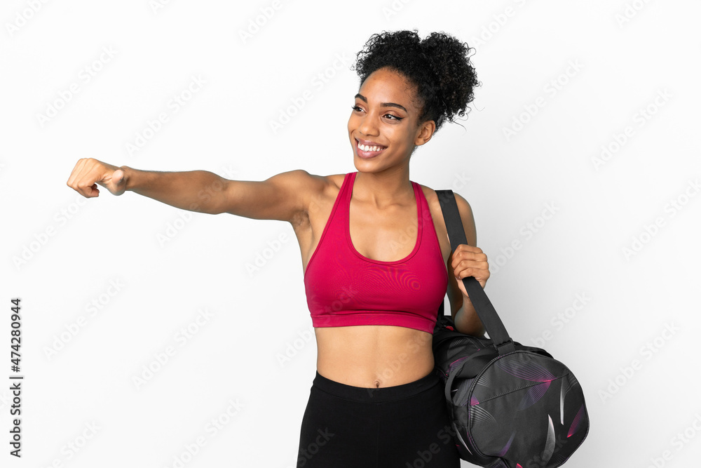 Young sport african american woman with sport bag isolated on blue background giving a thumbs up gesture
