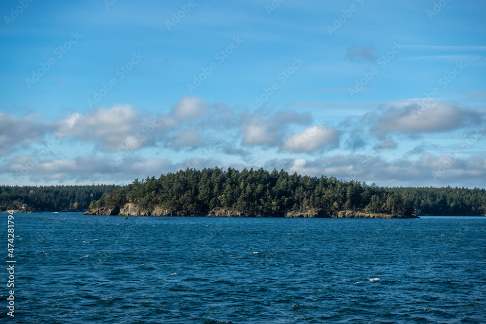 View of a vibrant blue sky above the San Juan Islands from the Anacortes Ferry in Washington.