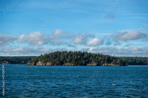 View of a vibrant blue sky above the San Juan Islands from the Anacortes Ferry in Washington.
