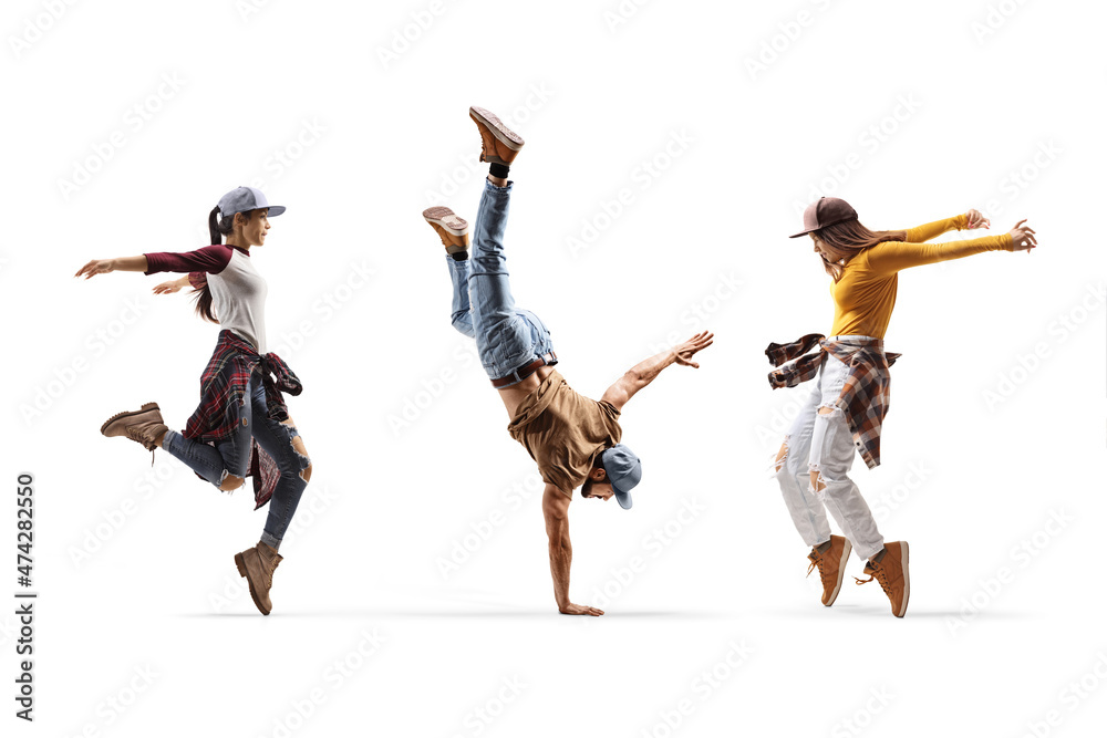 Two female dancers and one male dancer performing a hand stand - obrazy, fototapety, plakaty 