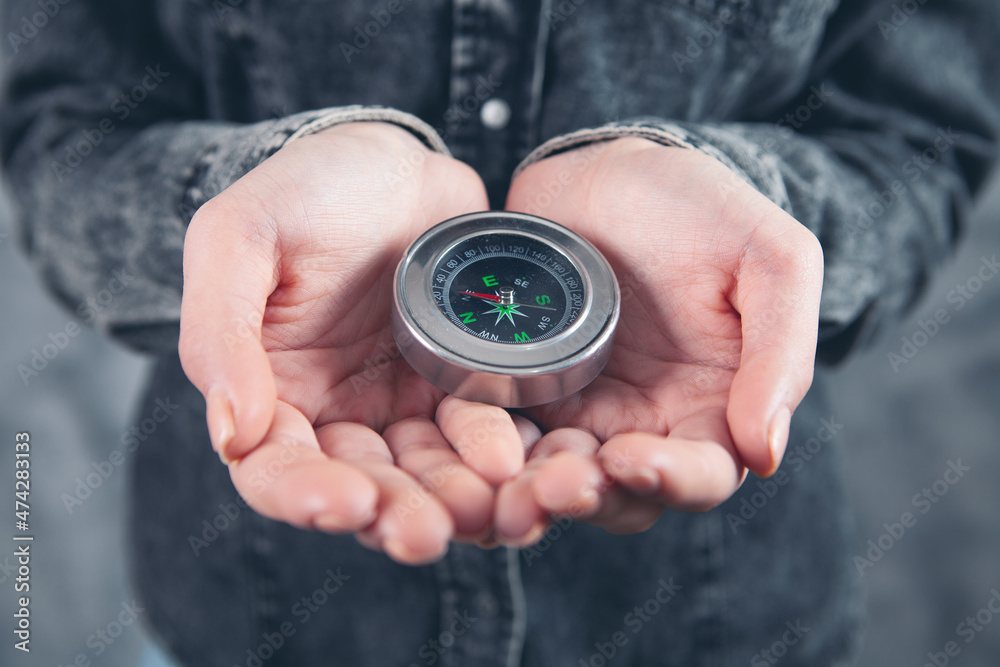 woman holding a compass in her hand woman holding a compass in her hand