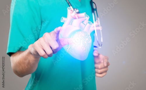 Young doctor touchstone virtual Heart in hand. Healthcare hospital service concept