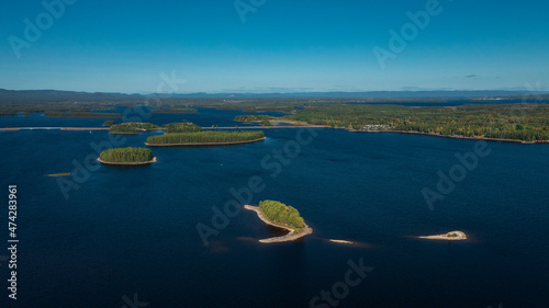 Lakeshore with islands at Lake Siljan from above with blue sky in Dalarna, Sweden. photo