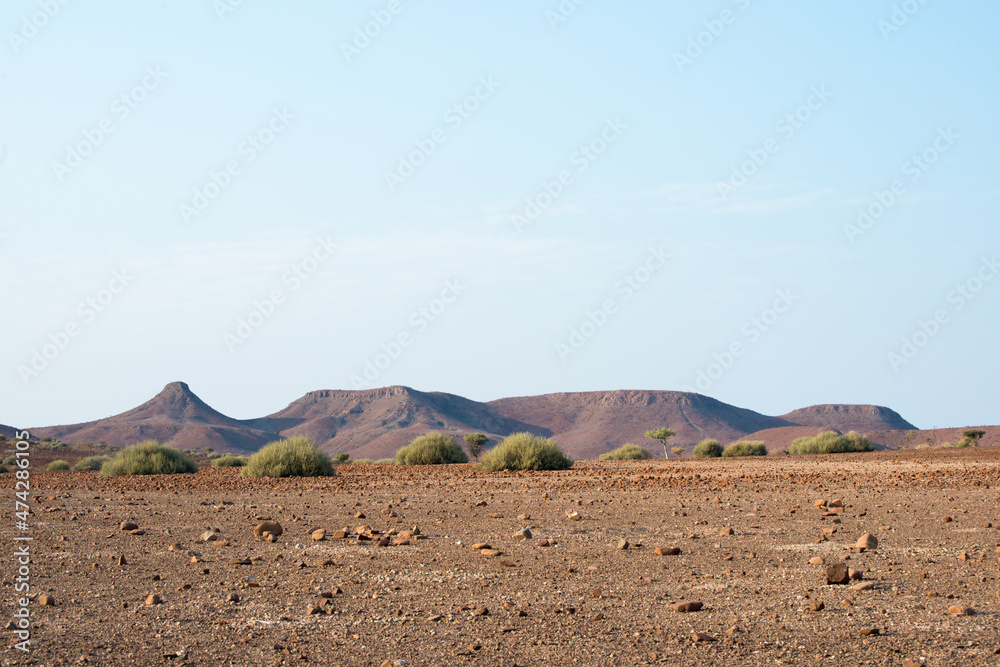 Beautiful arid landscape in Damaraland. Mountain chain and bushes. Namibia