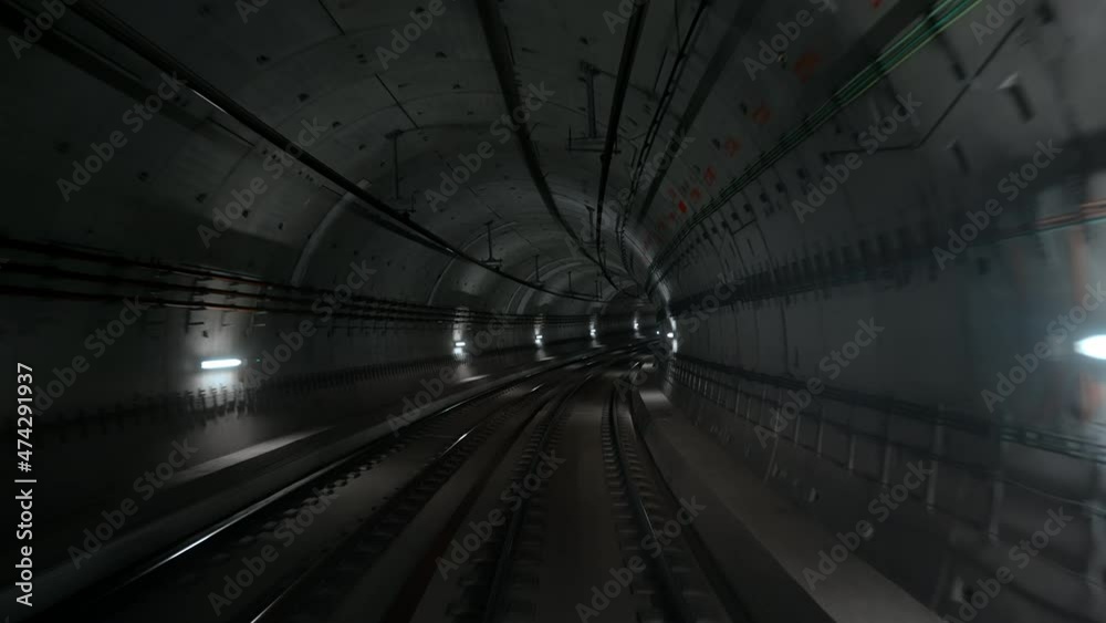 Front cabin view of driverless metro train moving forward through underground tunnel. Automated advanced transportation system, subway in Copenhagen, Denmark.