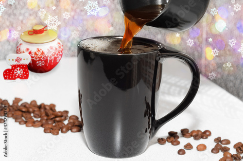 Obraz na plátně Coffee is poured into a mug on a Christmas background