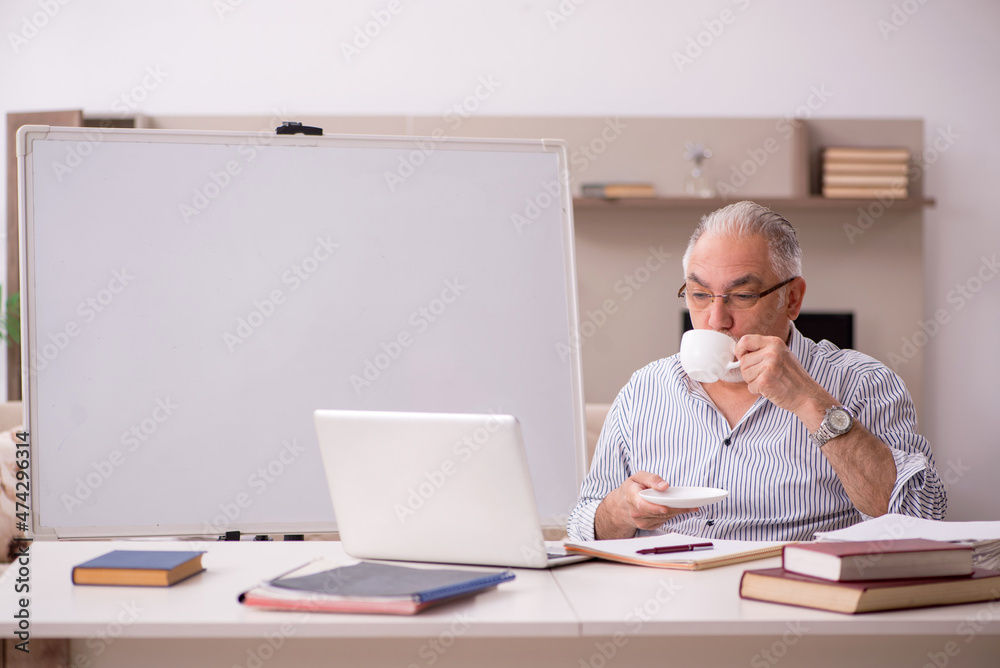 Old male employee working from home during pandemic Old male employee working from home during pandemic