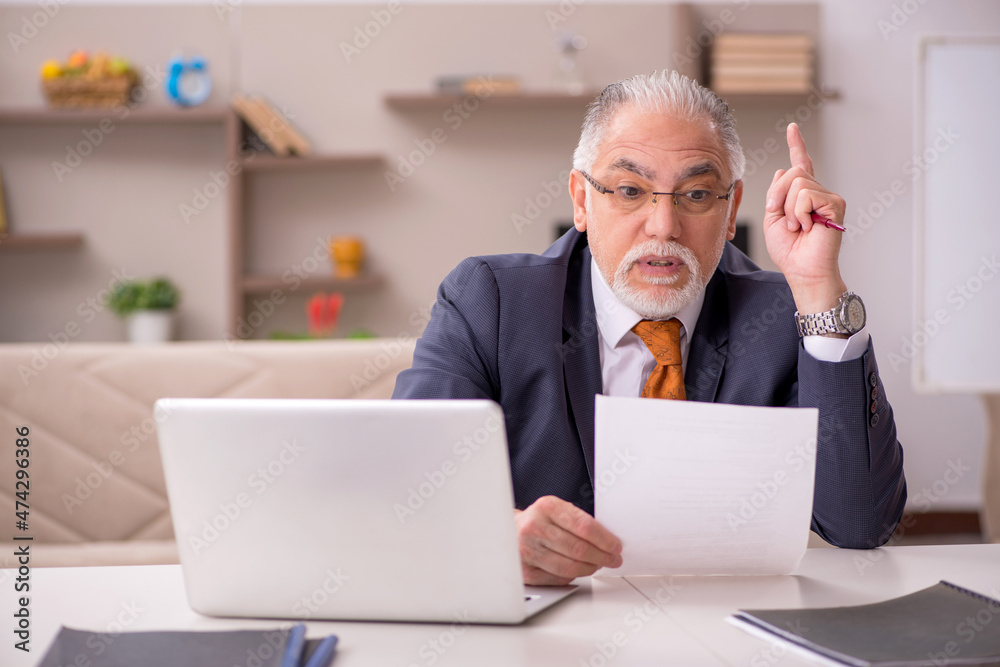 Old male employee working from home during pandemic Old male employee working from home during pandemic