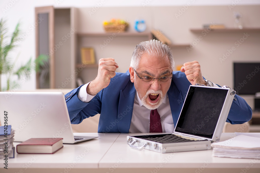 Old male employee and empty money case at home Old male employee and empty money case at home