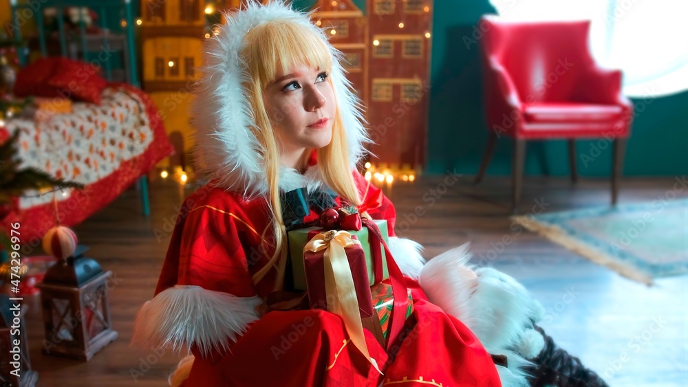 Cute girl cosplaying Christmas Miku Santa dress with gifts. New Year's elf. Sits on the floor