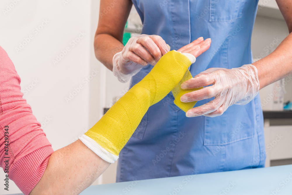 Surgery And Medical Theme Close Up Of An Arm And Wrist Plaster surgery-and-medical-theme-close-up-of-an-arm-and-wrist-plaster