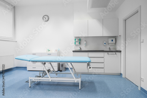Clean and comfortable room in the hospital with examination table. Doctor's office. Doctor's room close up. Hospital check-ins. photo