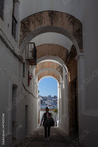 Woman walking through a white village in Andalusia