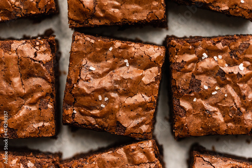 Overhead close up of salted chocolate brownies cut into squares.