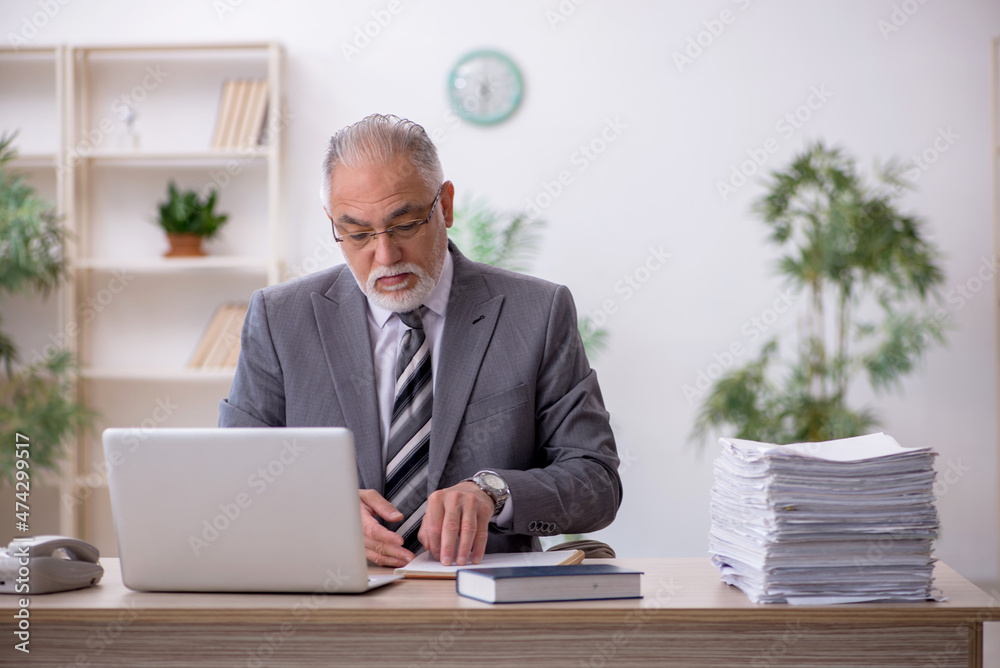 Old male employee and too much work in the office Old male employee and too much work in the office