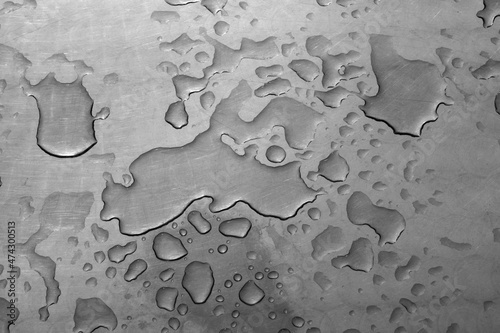 Closeup  of raindrops on a metal table
