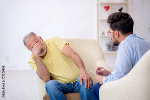 Old man visiting young male psychotherapist © Elnur
