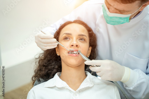 Woman having teeth examined at dentists Overview of dental caries prevention Medicine Stomatology and health care concept.