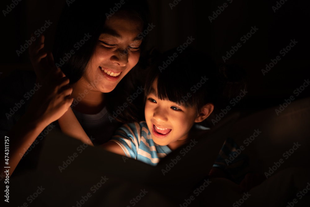 young Asian mother and little daughter girl on bed, cozy love sleepy at childhood home, at night young Asian mother and little daughter girl on bed, cozy love sleepy at childhood home, at night