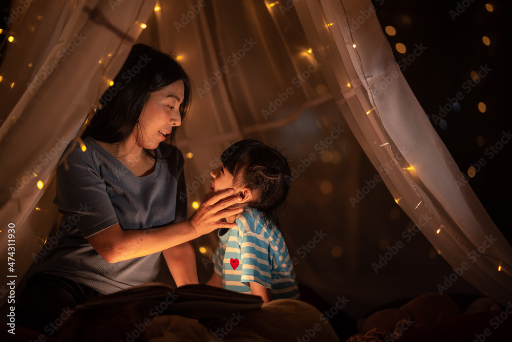 young Asian mother with little child daughter family happy in cozy night light at childhood home young Asian mother with little child daughter family happy in cozy night light at childhood home