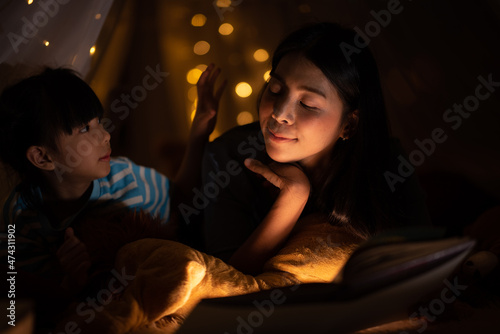 young Asian mother with lit...