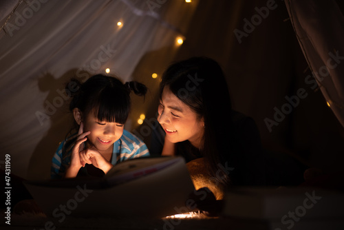 young Asian mother with lit...
