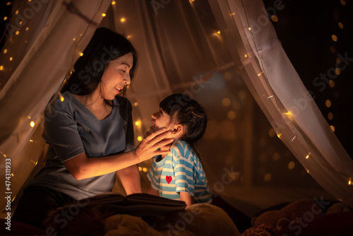 young Asian mother with lit...