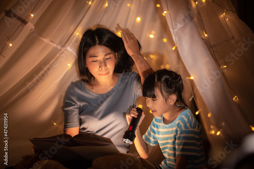 young Asian mother with lit...