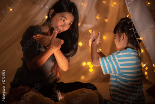 young Asian mother with lit...